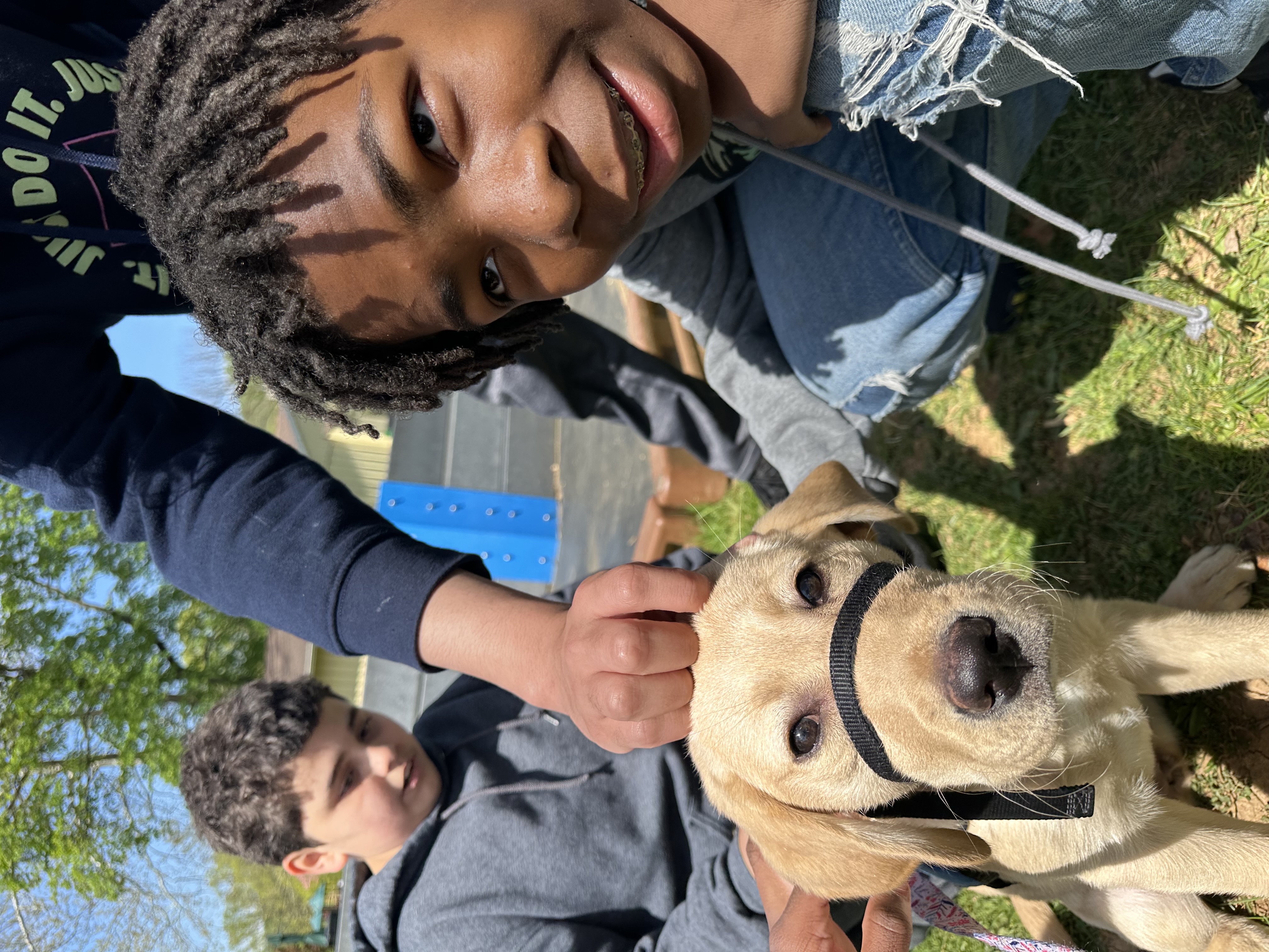 students petting honey the dog